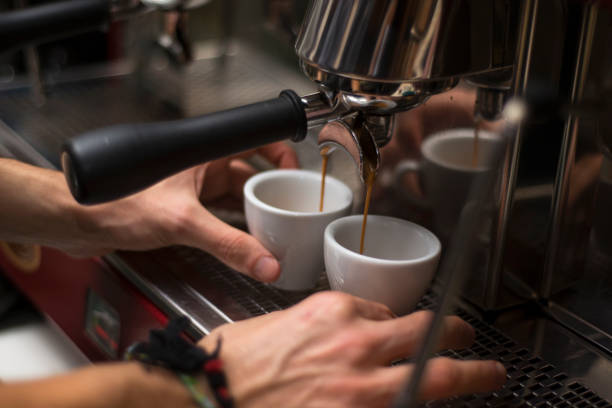 Barista preparing espresso in coffee machine stock photo