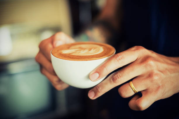 Baristas are coffee,by tattooed barista arm stock photo