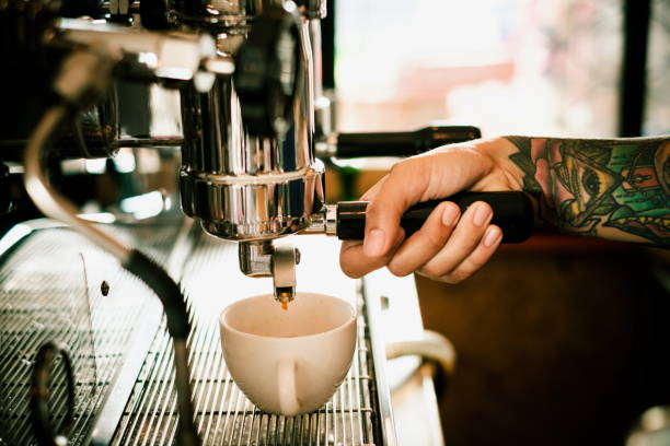 Baristas are coffee,by tattooed barista arm stock photo