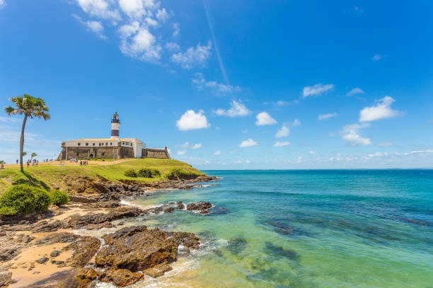 Barra's Lighthouse on a clear day in Bahia. A wide picture of the Barra's Lighthouse in Bahia, Brazil, taken in a bright and beautiful day. Colorful and satured taken with a Canon 6D. bahia state stock pictures, royalty-free photos & images