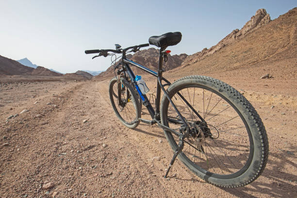 Barren desert landscape in hot climate with bike stock photo