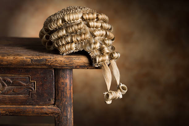 Barrister's wig Antique barrister's wig lying on an old wooden desk wig stock pictures, royalty-free photos & images