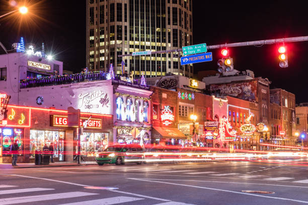 Bars and venues line Broadway in downtown Nashville. Nashville, Tennessee - December 5, 2017 : Bars and venues line Broadway in downtown Nashville. broadway nashville stock pictures, royalty-free photos & images