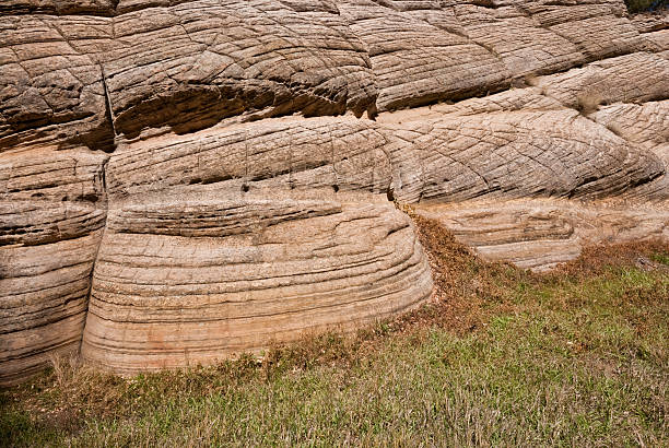 Base of Fisher Point Fisher Point is a large and beautifully colored formation of Coconino Sandstone at the western end of Walnut Canyon and the northern end of Sandy’s Canyon. Fisher Point is named for Ed Fisher, an early forest ranger. Fisher Point is located next to the Arizona Trail in the Coconino National Forest near Flagstaff, Arizona, USA. jeff goulden route 66 stock pictures, royalty-free photos & images
