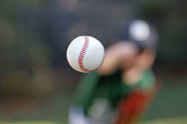 Baseball in mid air after being thrown by pitcher stock photo