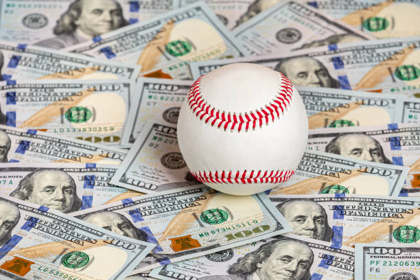 Baseball with cash money. Major league strike, lockout and sports betting concept. background, no people, copy space rich strike stock pictures, royalty-free photos & images