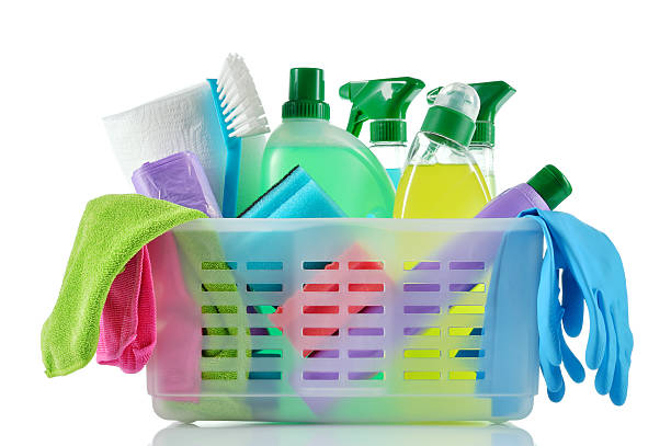 A basket full of cleaning supplies and cloths stock photo