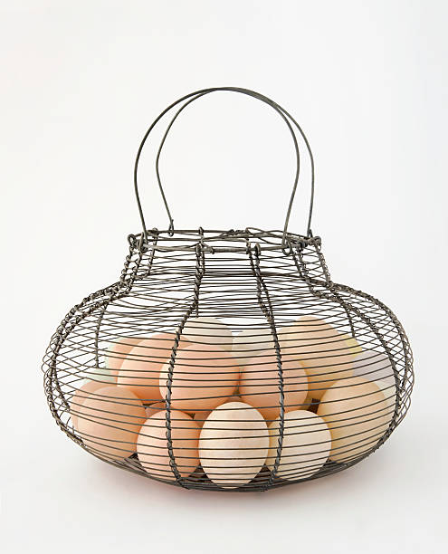 Basket with eggs in front of white background stock photo