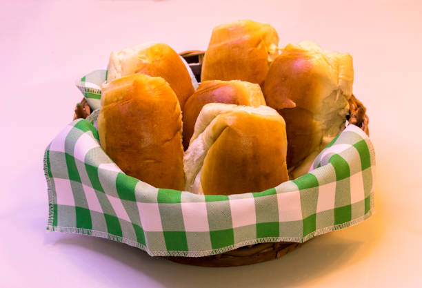 Basket with plaid towel and several  delicious milk breads - Pão de Cará stock photo