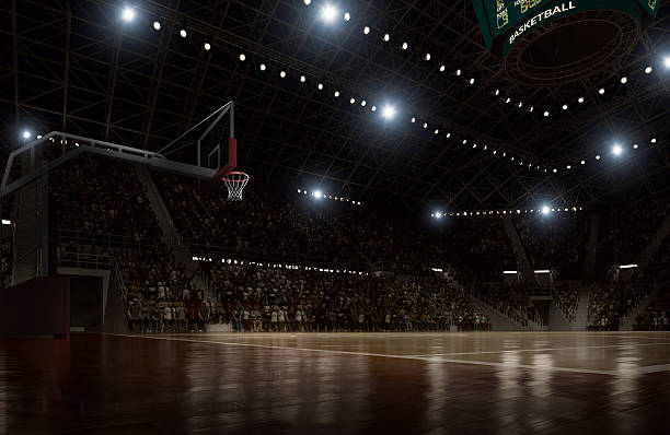 Basketball arena Indoor floodlit basketball arena full of spectators - full 3D basketball court stock pictures, royalty-free photos & images