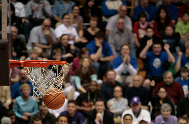basketball ball and backboard with fans in the background. - basketboll lagsport bildbanksfoton och bilder