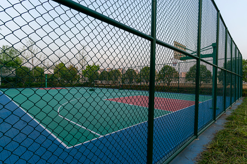 basketball court behind barbed wire