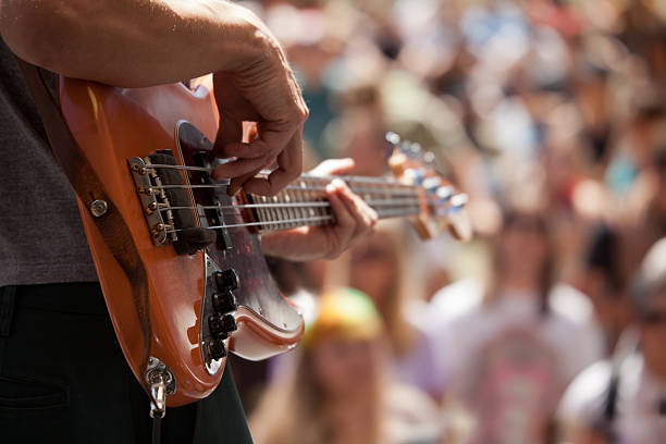 bass player in front of crowd stock photo