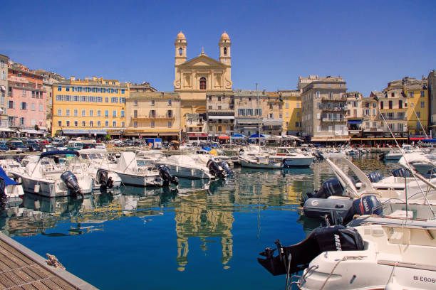 Bastia, Corsica, France Bastia, Corsica, France - June 02, 2019: The old port (the Vieux Port), in Bastia, Corsica, France. The small port with yachts, surrounded by the medieval houses, street cafes, tiny shops, with the St. Jean Baptiste church bastia stock pictures, royalty-free photos & images