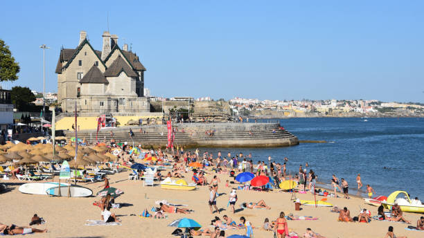 Bathers enjoying hot summer weather on the beaches of Cascais. Lisbon, Portugal. stock photo