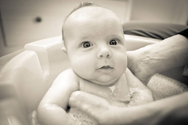 bathing baby stock photo