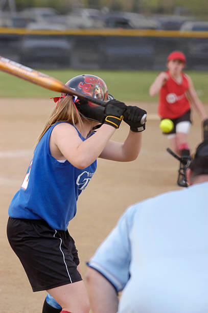 Batter up "Girls softball, from behind home plate." batting sports activity stock pictures, royalty-free photos & images