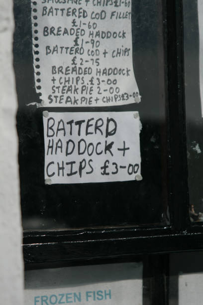 Battered haddock and chips misspelled handwritten sign, Dumfries stock photo