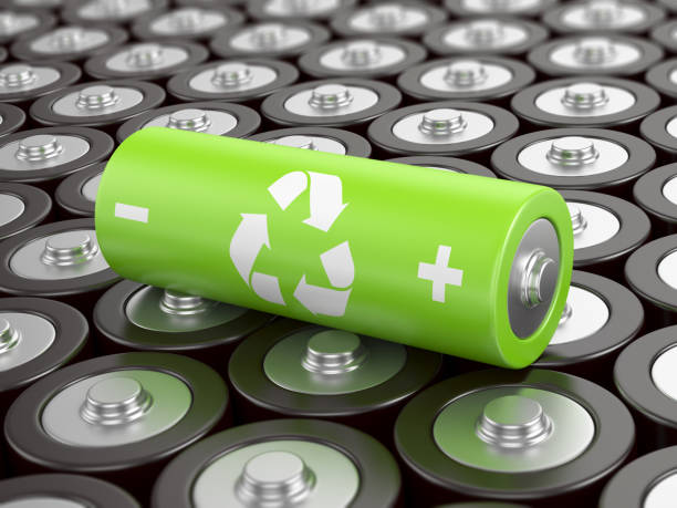 Battery recycling Battery recycling concept. Green battery with recycling symbol, surrounded by other batteries. battery stock pictures, royalty-free photos & images