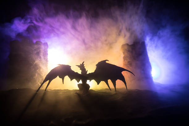 Battle between dragon and heroic soldiers. Creative table decoration. Selective focus Fantasy battle scene with dragons attacking a medieval castle at night. Battle between dragon and heroic soldiers. Creative table decoration. Selective focus dragon photos stock pictures, royalty-free photos & images
