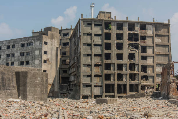 Battleship Island (Gunkanjima, Hashima, Gunkanjima, Gunkanjima, Gunkanjima) Hashima Island (端島 or simply Hashima — -shima is a Japanese suffix for island), commonly called Gunkanjima (軍艦島; meaning Battleship Island), is an abandoned island lying about 15 kilometers (9 miles) from the city of Nagasaki, in southern Japan. It is one of 505 uninhabited islands in Nagasaki Prefecture. The island's most notable features are its abandoned concrete buildings, undisturbed except by nature, and the surrounding sea wall. While the island is a symbol of the rapid industrialization of Japan, it is also a reminder of its dark history as a site of forced labor prior to and during the Second World War. sites of japan's meiji industrial revolution stock pictures, royalty-free photos & images