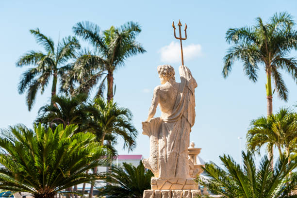 Bayfront residential community and shopping center with Neptune statue, sculpture fountain, palm trees, blue sky Naples, USA - April 30, 2018: Bayfront residential community and shopping center with Neptune statue, sculpture fountain, palm trees, blue sky poseidon statue stock pictures, royalty-free photos & images