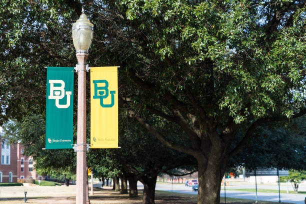 Baylor University light post flags, with copy space Waco, TX / USA - January 12, 2020: Baylor University banners on light poles, with copy space baylor basketball stock pictures, royalty-free photos & images
