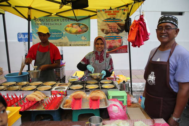 Bazaar Ramadan in Kuala Lumpur KUALA LUMPUR, MALAYSIA - 11 MAY 2019: One of the vendor at bazaar Ramadan selling apam balik, the crispy turnover pancake with sweet corn and sugar peanut filling. Muslim around the world celebrate the month of Ramadan by abstaining from eating, drinking from dawn to dusk. business Malaysia stock pictures, royalty-free photos & images