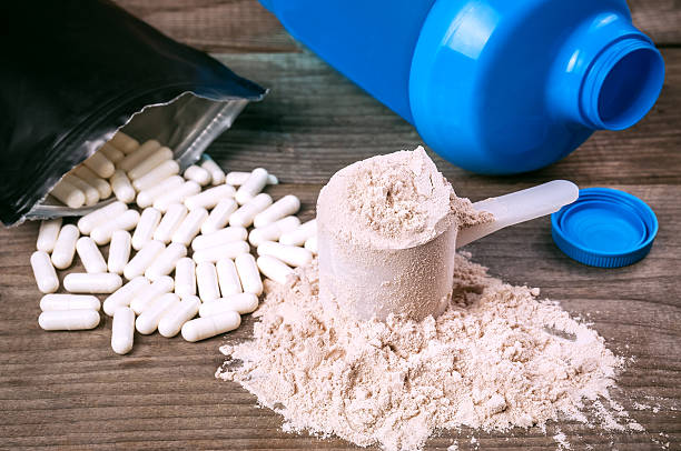bcaa pills and protein bcaa pills and heap of protein powder ground culinary stock pictures, royalty-free photos & images