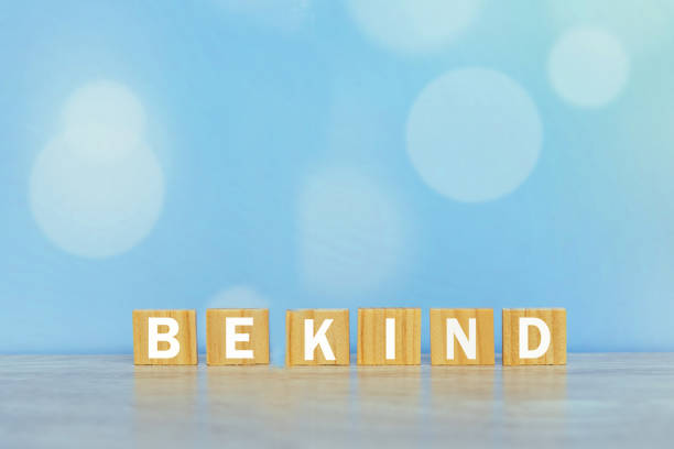 Be Kind. Inspirational words on wooden blocks - Be kind. On vintage soft blue bokeh background. Kindness motivational quote concept. affectionate stock pictures, royalty-free photos & images