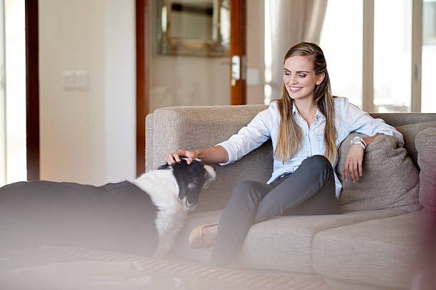 Shot of an attractive young woman spending time with her dog at...