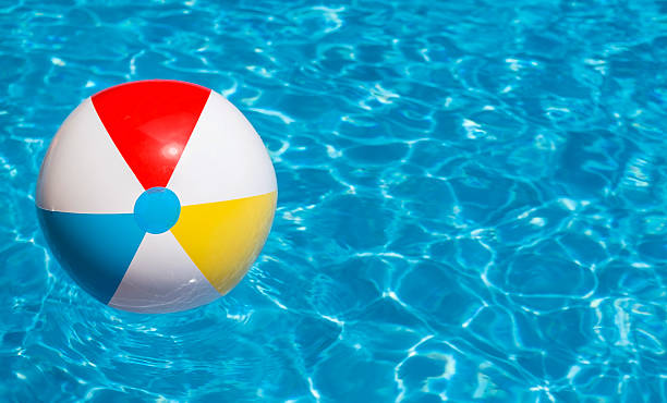 Royalty Free Colorful Beach Ball Floating In A Swimming Pool Pictures, Images and Stock Photos