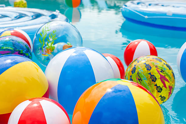 Beach Balls Floating in Pool stock photo