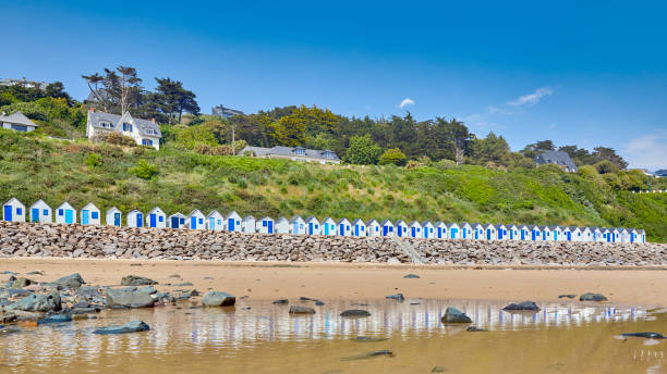Beach huts at Plage de Carteret, France Plage de Cartret beach with seaside huts on a sunny day. in France barneville carteret stock pictures, royalty-free photos & images
