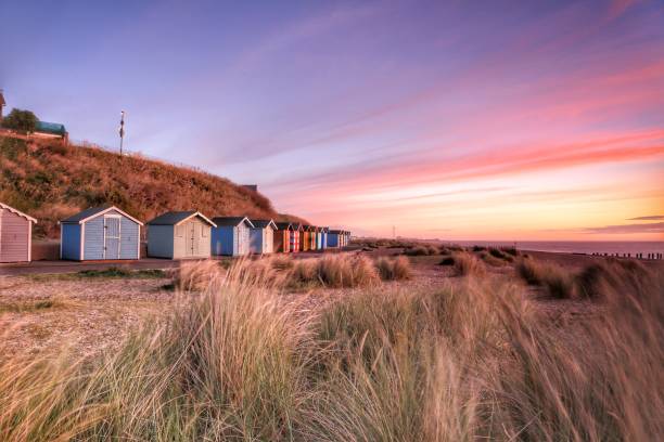 Beach huts early in the morning Beach huts early in the morning beach hut stock pictures, royalty-free photos & images