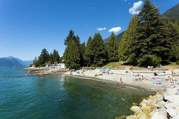 Beach Lions Bay West Vancouver West Vancouver, British Columbia, Canada - August 17, 2016: Scenic view of people sunbating on a beach located in Lions Bay in West Vancouver, British Columbia, Canada. west vancouver stock pictures, royalty-free photos & images