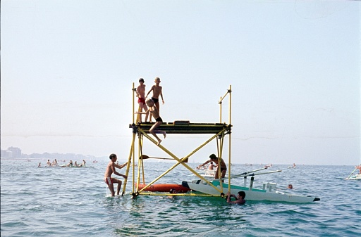 Rimini, Emilia-Romagna, Italy, 1967. Bathing island / bathing pond with kids swimming in the Adriatic Sea. The Panton is located in front of the beach of Rimini, one of the popular seaside resorts on the Adriatic coast in the sixties.