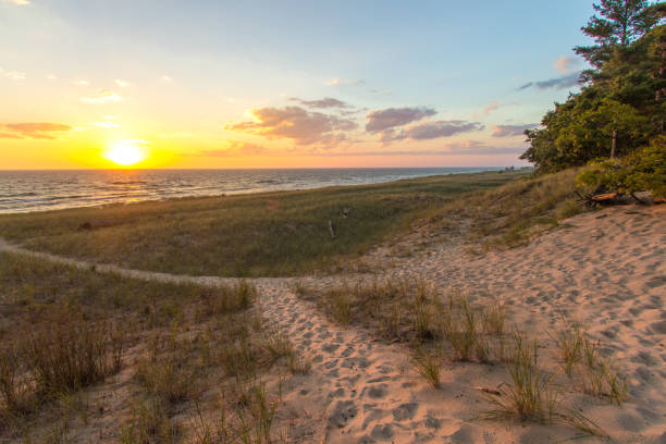 Beach Path Sunset On Sandy Beach With Dune Grass In Port Huron Michigan stock photo