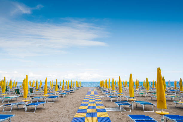 Beach resort with sun beds and beach umbrellas stock photo