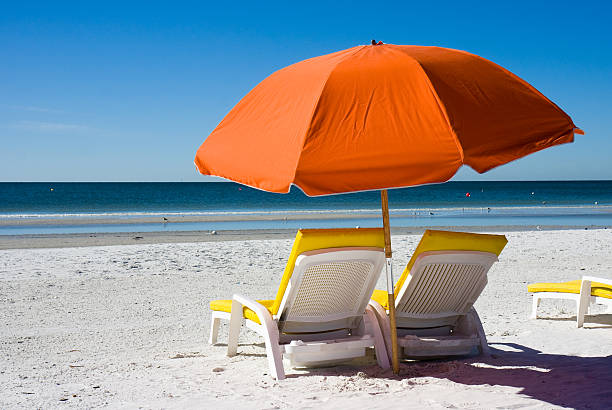 Beach Umbrella and Lounge Chair stock photo