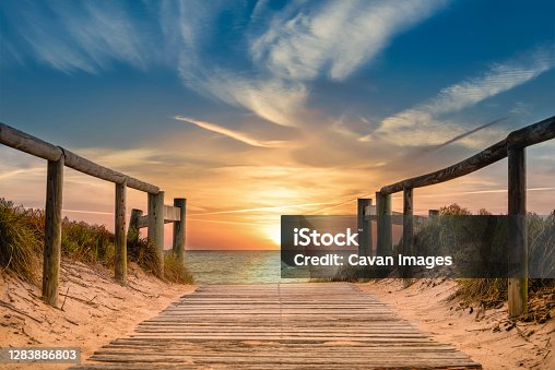 istock Beachside pathway leading to the ocean with spectacular sunrise 1283886803