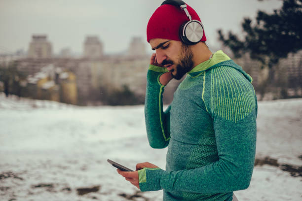 Bearded athlete listening music outdoor stock photo