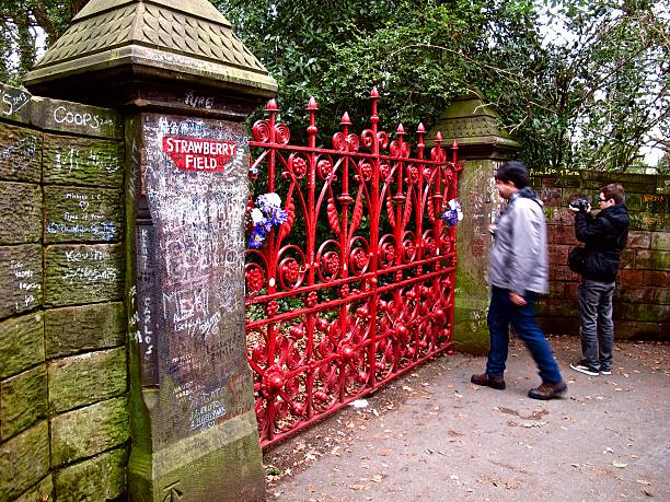 Beatles fans at Strawberry Field gates in Liverpool stock photo