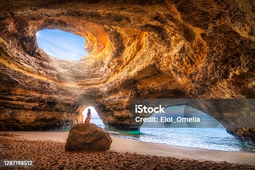 istock beatuful woman in Benagil Cave, Algarve, Portugal 1287198512