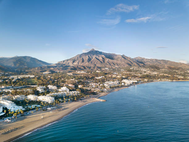 Beautiful aerial Panoramic View of Marbella, Nueva Andalucia and Puerto Banus area Beautiful aerial Panoramic View of Marbella, Nueva Andalucia and Puerto Banus area. Beautiful colours at sunset. La Concha mountain in background. marbella stock pictures, royalty-free photos & images