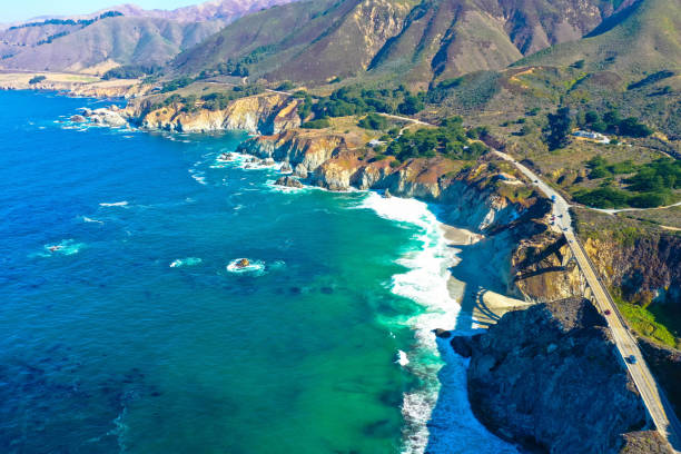 A beautiful aerial view of the California Coastline along the panoramic Route, State Road 1, California USA Aerial panoramic view of historic Bixby Creek Bridge along world famous Pacific Coast Highway, California natural landmark stock pictures, royalty-free photos & images