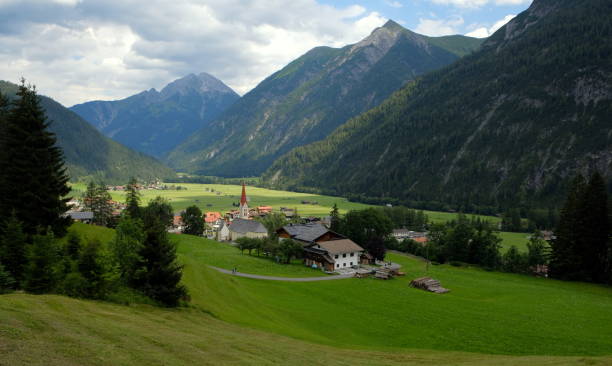 Beautiful alpine landscape with green meadows, alpine cottages and mountain peaks, Lechtal, Lech, Austria Beautiful alpine landscape with green meadows, alpine cottages and mountain peaks, Lechtal, Lech, Austria, Summer 2020 lech valley stock pictures, royalty-free photos & images