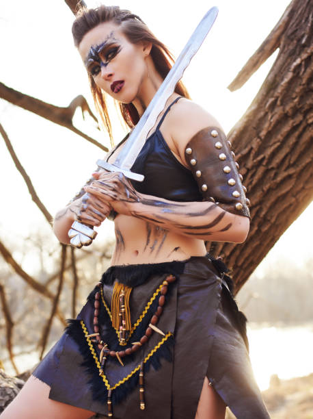 Beautiful amazon woman posing with sword stock photo