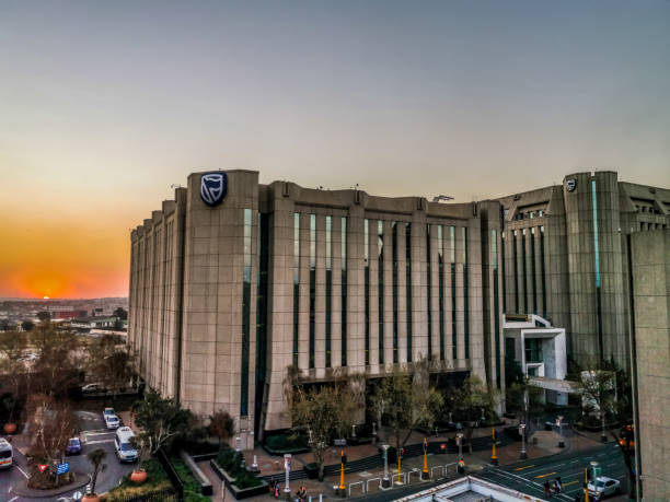 Beautiful and tall Standard bank buildings in Simmonds street Selby Johannesburg CBD area under a cloudy and sunset sky Beautiful and tall Standard bank buildings in Simmonds street Selby Johannesburg CBD area under a cloudy and sunset sky marshall photos stock pictures, royalty-free photos & images