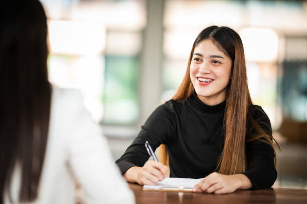 Beautiful Asian female student sit for exam at university classroom students sitting in the row education lifestyle university college stock photo